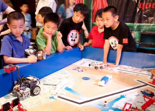 Students watch Chinese FLL guests Martin Wang and August Bing (pictured in black). All photos by Kara Chin