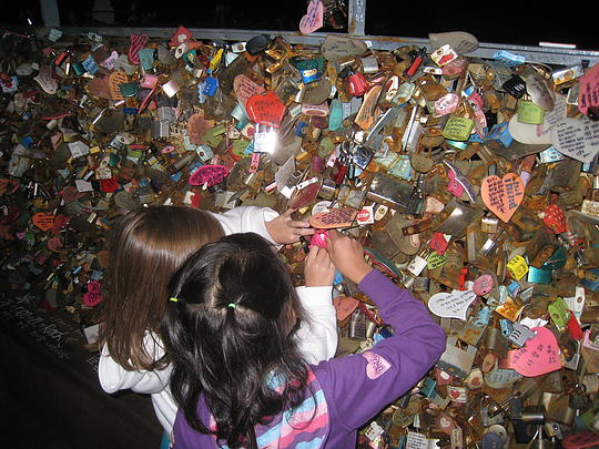 Ava and June securing their Lock of Love on the N Tower fence.