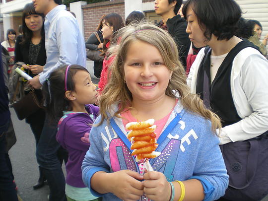Leah with her Tteok-kkochi; our hosts Sue and her daughter June are in the background.