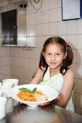Maaria Trias (7, attends Dulwich College Beijing) serves up a mean plate of spaghetti