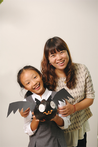 Keystone Elementary Art Teacher Nan Lu and student Coco Zhai (age 9) with their gourd-geous creation