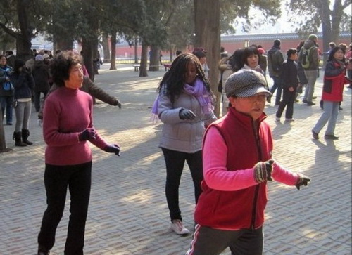 Eleventh grader Stephane dances with the taitais at Tiantan Park