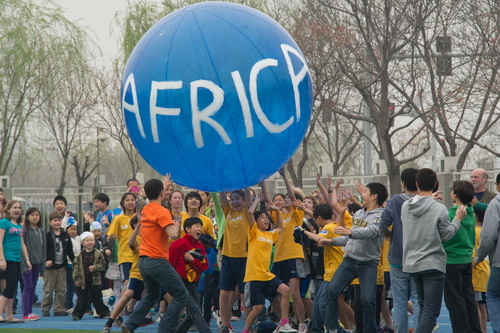 ISB students pass around a giant plastic ball for Earth Day