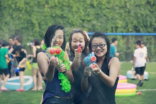 ...and then. Jiang (on the right) taking part in the last water fight social of her senior year.