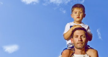 Kid on dad's shoulders