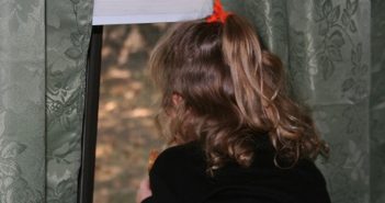 girl looks out window