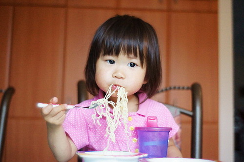 Young Girl Eating Noodles